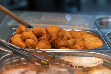 Fried food - cutlets and cauliflower and vegetable salad in containers for lunch