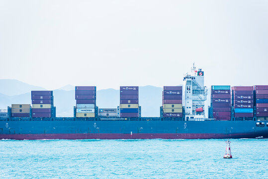 Busan, South Korea - cargo container ship CHRISTA SCHULTE sailing out of the sea port near the Korean coast. 