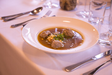 Dumpling soup being prepared for serving at a restaurant on a wedding table