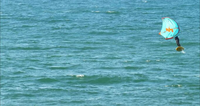 Wing foil flying over the ocean