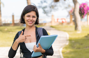 Fototapeta premium Young Bulgarian student woman at outdoors and pointing it