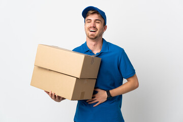 Young delivery blonde man isolated on white background smiling a lot