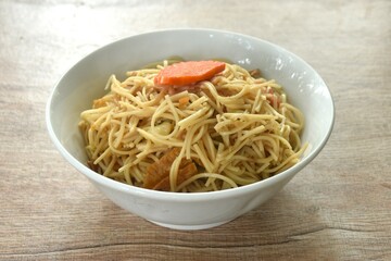 fried vegetarian Chinese yellow rice noodles with cabbage and carrot on bowl