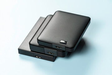 External drives lying on blue background. Reliability and functionality.