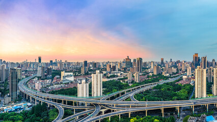 Fototapeta premium Aerial view of highway intersection and cityscape in Shanghai, China