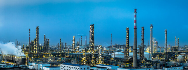 Panorama of illuminated oil refinery and chemical plant at night