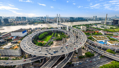 Aerial view of busy highway junction and cityscape in Shanghai, China