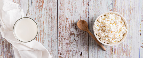Farm homemade cottage cheese in a bowl on the table top view web banner