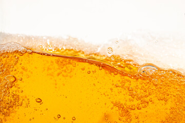 Close up bright orange Oil or beer splash texture and nature waves, Beautiful waves curve and little bubbles smooth for graphic design and background, Oil Bubbles, Soft beer bubbles, Selective focus