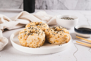 Spicy rice and beef donuts on a plate on the table