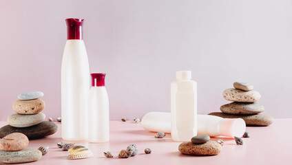 Set of various cosmetic bottles for feminine care on pink web banner