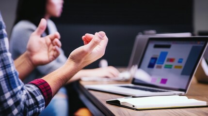 Collaborative business meeting showcasing a laptop with vibrant graphs and charts
