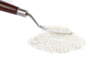 White Powder With a Metal Spatula on a Clean Surface in a Bright Setting