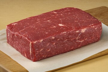 Fototapeta premium Freshly cut beef resting on a butcher block at a culinary preparation area Generative AI