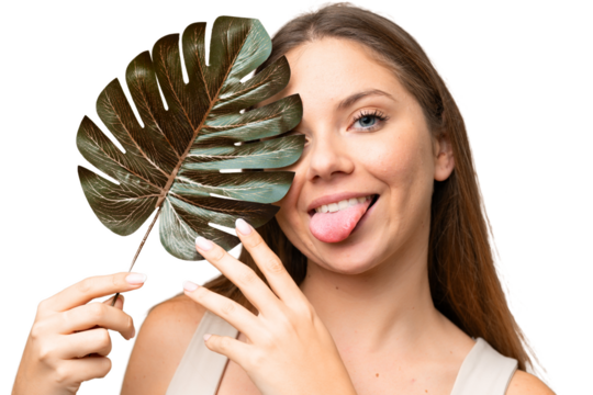 Young blonde woman over isolated chroma key background holding a palm leaf with happy expression. Close up portrait