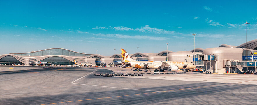 23 January 2025, Abu Dhabi, UAE: Etihad airplane taxiing on the runway of AUH airport, ready for departure under a clear blue sky
