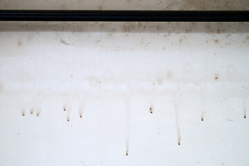 Dirty white wall in grungy loft with moisture and spider web