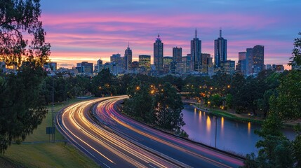 Fototapeta premium Melbourne Cityscape at Dawn: A Breathtaking Panorama of City Skyline, River, and Highway Light Trails