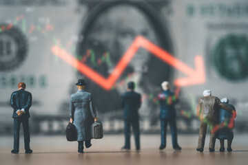 Miniature figure standing with USD banknote and red down arrow for United States of America have...