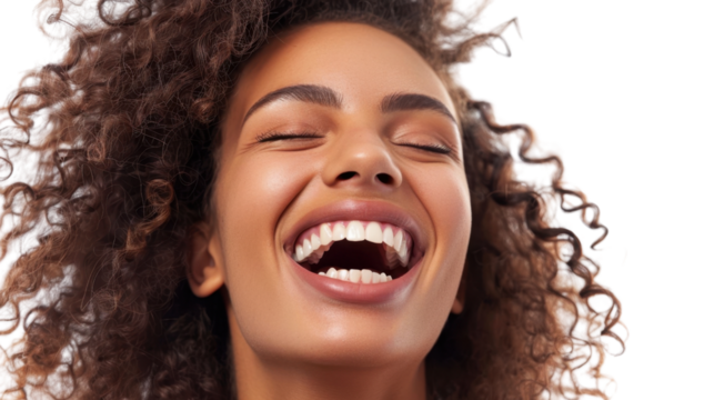 Close-up portrait of cheerful young woman with curly hair laughing with closed eyes on transparent background
