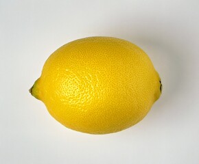 A single yellow lemon on a white background