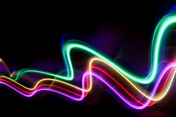 A long exposure photograph of colourful lights in swirl patterns of motion against a black background