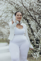 Overweight, young woman doing sports outdoors. Weight loss concept. Fat woman doing exercises.