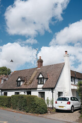 traditional english cottage with a white car