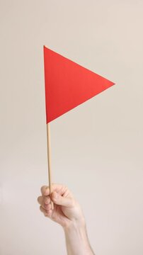 Red flag in the hands of a man. Vertical video. Choosing a partner for a relationship concept. Bad qualities of a boyfriend.