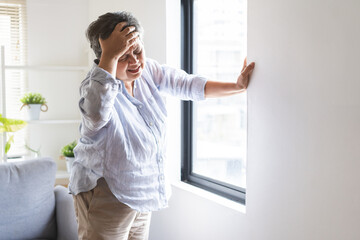 Dizzy asian elderly woman headache or migraine pain. suffering from vertigo, old standing up...