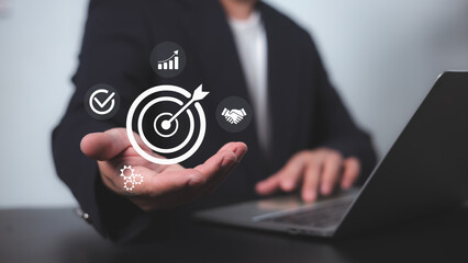 Targeting business concept, business objective, Successful business growth, Goals business, Hand man hold target business icon for strategic planning to business growth and target customer group.
