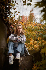 Garden Portrait Beautiful Young Woman in Chic Checkered Jacket Relaxes on White Wooden Bench Amidst...