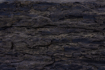 Closeup of weathered black cliff texture