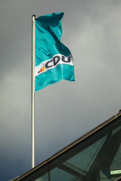 Berlin, Germany - 16 March 2025: Flag with Logo of the German Conservative Party CDU (Christian Democratic Union) on Top of its Headquarters Building; Close-up; Copyspace