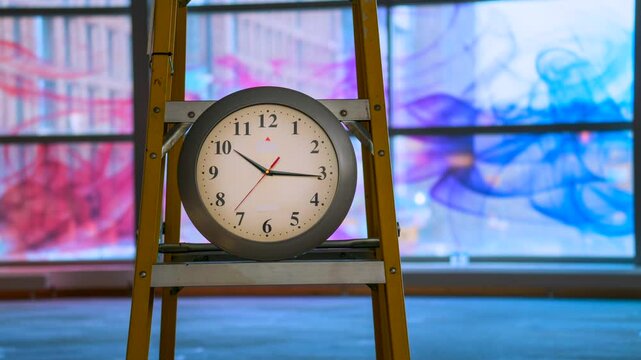 A time lapse video of a clock on a ladder elegantly capturing the passage of time.