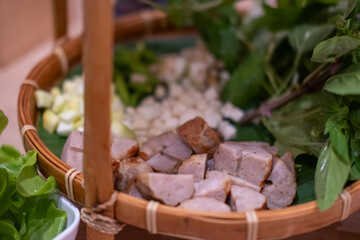 Naem Nueng or Nam Nuong, a Vietnamese style meatballs which is wrapped in rice paper and several fresh herbs and vegetables.