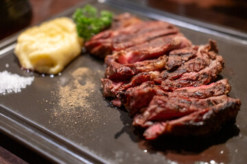 Medium rare rib eye angus steak served on plate