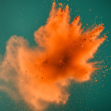 A high-energy burst of bright orange powder contrasting against a teal background