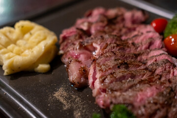 Medium rare rib eye angus steak served on plate