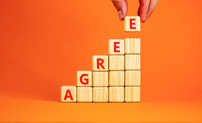 Agree symbol. Concept word Agree on beautiful wooden blocks. Beautiful orange table orange...