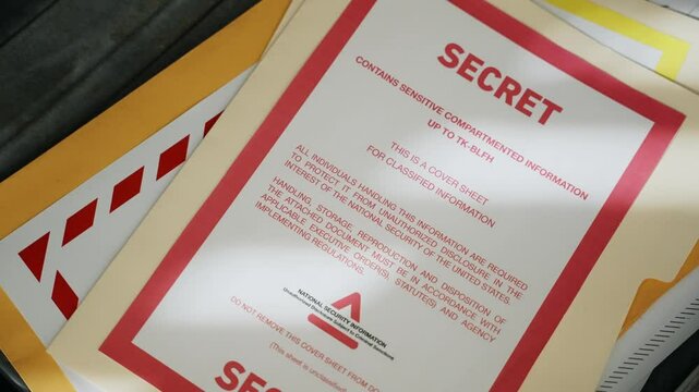 Close up on briefcase being opened revealing top secret envelopes and documents. Suitcase hand bag containing leaked information with government secrets and sensitive agency material and surveillance