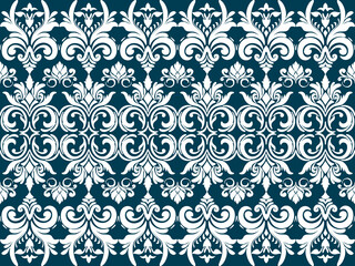A decorative pattern featuring intricate white floral and scroll designs on a dark teal background.