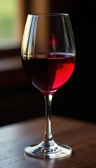 Rich red wine fills a stemmed goblet, light reflecting , photography, liquid, drinkware
