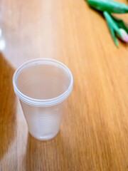 empty plastic cup on office desk close up