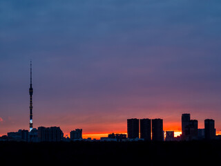Obraz premium high-rise houses and TV tower at winter sunrise