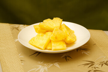 Cut pineapple on a simple background