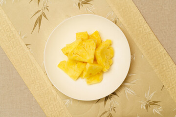 Cut pineapple on a simple background