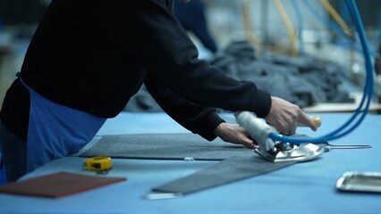 Workers in the garment factory are ironing clothes