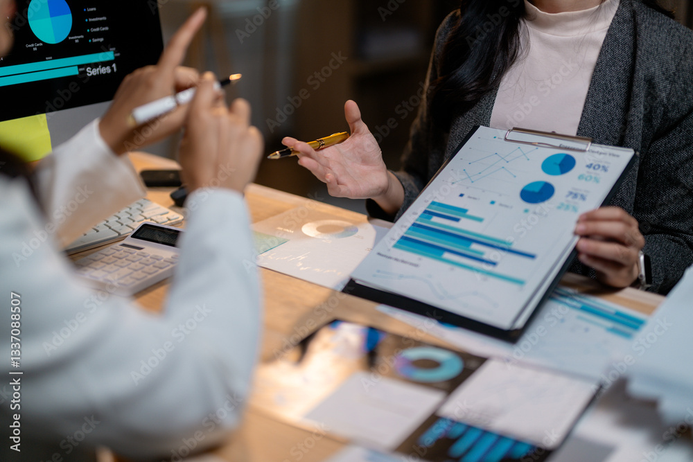 Poster businesswomen discussing marketing strategy showing charts and graphs on clipboard and computer scre