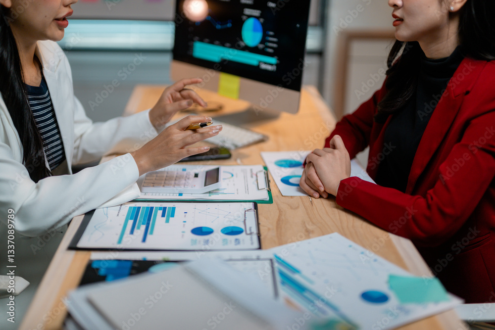 Poster Businesswomen discussing marketing strategy using charts and graphs on computer and documents